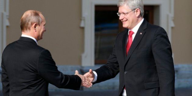 Russia's President Vladimir Putin, left, shakes hands with Canada's Prime Minister Stephen Harper during arrivals for the G-20 summit at the Konstantin Palace in St. Petersburg, Russia on Thursday, Sept. 5, 2013. The threat of missiles over the Mediterranean is weighing on world leaders meeting on the shores of the Baltic this week, and eclipsing economic battles that usually dominate when the G-20 world economies meet. (AP Photo/Alexander Zemlianichenko)