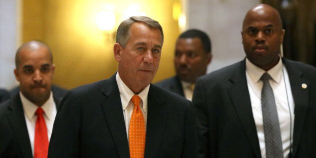 WASHINGTON, DC - NOVEMBER 14: House Speaker John Boehner (R-OH)(2nd-L) is escorted by his security detail as he walks to the House chamber before a vote at the US Capitol, November 14, 2014 in Washington, DC. The Republican led House voted to approve legislation to authorize construction of the controversial Keystone XL oil pipeline. . (Photo by Mark Wilson/Getty Images)