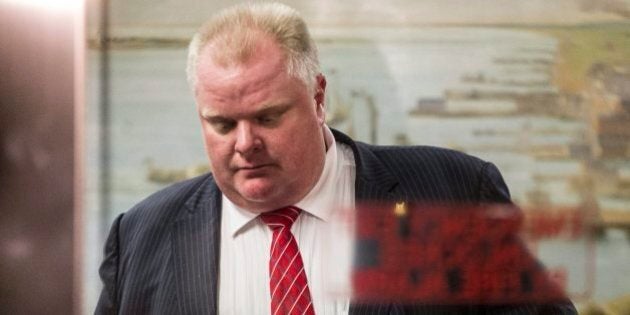 Toronto Mayor Rob Ford leaves city hall for the day after councillors passed motions to limit his powers on Monday November 18, 2013 THE CANADIAN PRESS/Chris Young