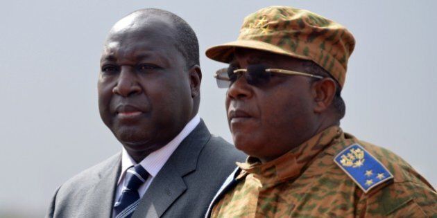 Burkina Faso's chief of staff general Nabere Honore Traore (R) and opposition leader Zephirin Diabre (L) attend a meeting on November 5, 2014 at Ouagadougou airport. Three west African leaders held talks behind closed doors with Burkina Faso's new military leader on November 5 to pressure him into swiftly handing over power to a civilian government after the fall of president Blaise Compaore. The presidents of Nigeria, Ghana and Senegal flew into Ouagadougou after Canada suspended its aid to the impoverished west African nation and other nations considered similar moves. AFP PHOTO / ISSOUF SANOGO (Photo credit should read ISSOUF SANOGO/AFP/Getty Images)