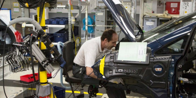 An employee works under the trunk of an Opel Corsa automobile at the Adam Opel AG factory, operated by General Motors Co. (GM), in Eisenach, Germany, on Wednesday, April 23, 2014. European sales at Opel and its U.K. sister brand Vauxhall gained 8.5 percent to 226,888 cars in the first quarter, slightly better than the 8.1 percent increase for the market overall, according to ACEA data. Photographer: Martin Leissl/Bloomberg via Getty Images