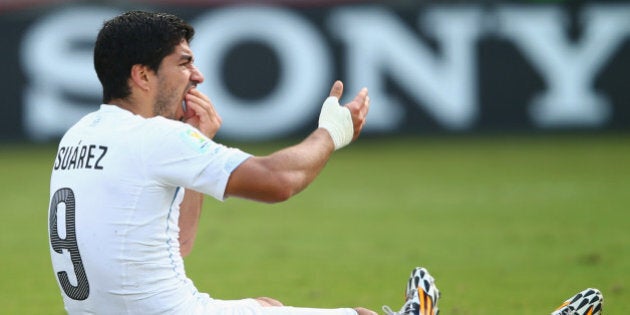 NATAL, BRAZIL - JUNE 24: Luis Suarez of Uruguay reacts after a clash during the 2014 FIFA World Cup Brazil Group D match between Italy and Uruguay at Estadio das Dunas on June 24, 2014 in Natal, Brazil. (Photo by Clive Rose/Getty Images)