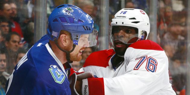 VANCOUVER, BC - OCTOBER 30: Daniel Sedin #22 of the Vancouver Canucks and P.K. Subban #76 of the Montreal Canadiens battle along the boards during their NHL game at Rogers Arena October 30, 2014 in Vancouver, British Columbia, Canada. (Photo by Jeff Vinnick/NHLI via Getty Images)