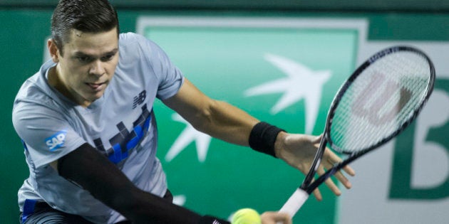 Milos Raonic of Canada returns the ball to Roberto Bautista of Spain during their third round match at the ATP World Tour Masters tennis tournament at Bercy stadium in Paris, France, Thursday, Oct. 30, 2014. (AP Photo/Jacques Brinon)