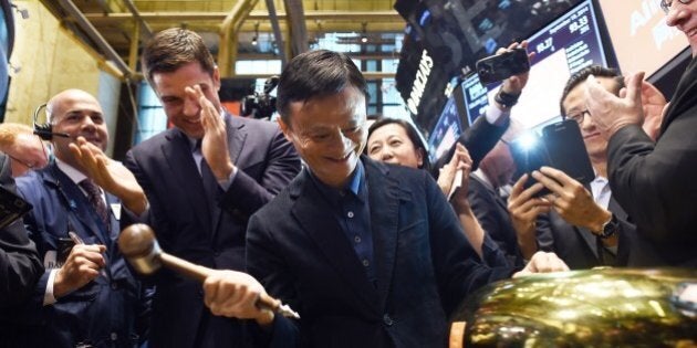 Chinese online retail giant Alibaba founder Jack Ma rings a bell to open trading on the floor at the New York Stock Exchange in New York on September 19, 2014. A buying frenzy sent Alibaba shares sharply higher Friday as the Chinese online giant made its historic Wall Street trading debut. In early trades after the record public share offering, Alibaba leapt from an opening price of $68 to nearly $100 and, while it dropped back, was still up some 38 percent at $94.08 after 10 minutes. AFP PHOTO/Jewel Samad (Photo credit should read JEWEL SAMAD/AFP/Getty Images)