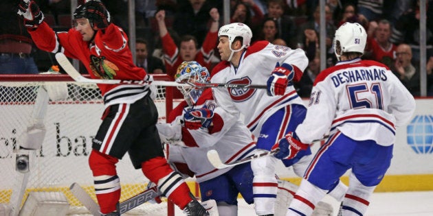 CHICAGO, IL - APRIL 09: Patrick Sharp #10 of the Chicago Blackhawks celebrates his game-winning goal in overtime in front of Peter Budaj #30, Mike Weaver #43 and David Desharnais #51 of the Montreal Canadiens at the United Center on April 9, 2014 in Chicago, Illinois. The Blackhawks defeated the Canadiens 3-2 in overtime. (Photo by Jonathan Daniel/Getty Images)