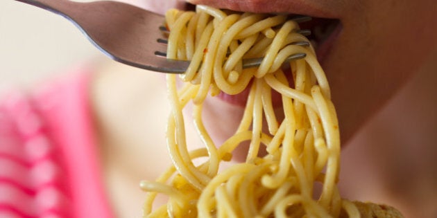 Beautiful young women are eating spaghetti in spicy