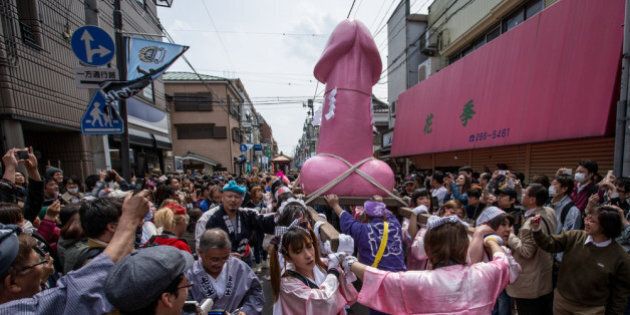 KAWASAKI, JAPAN - APRIL 06: A large pink phallic-shaped 'Mikoshi' is paraded through the streets during Kanamara Matsuri (Festival of the Steel Phallus) on April 6, 2014 in Kawasaki, Japan. The Kanamara Festival is held annually on the first Sunday of April. The penis is the central theme of the festival, focused at the local penis-venerating shrine which was once frequented by prostitutes who came to pray for business prosperity and protection against sexually transmitted diseases. Today the festival has become a popular tourist attraction and is used to raise money for HIV awareness and research. (Photo by Chris McGrath/Getty Images)