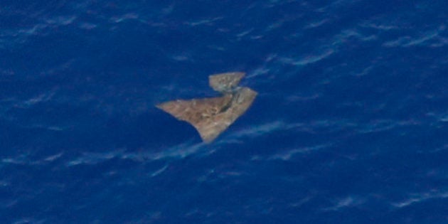 IN FLIGHT - MARCH 29: An object floats in the southern Indian Ocean in this picture taken from a Royal New Zealand Air Force P-3K2 Orion aircraft searching for missing Malaysian Airlines flight MH370 on March 29, 2014 over the southern Indian Ocean. Chinese ships trawled a new area in the Indian Ocean for a missing Malaysian passenger jet on Saturday, as the search for Flight MH370 entered its fourth week amid a series of false dawns over sightings of debris. The Malaysian airliner disappeared on March 8 with 239 passengers and crew on board and is suspected to have crashed into the southern Indian Ocean. (Photo by Jason Reed-Pool/Getty Images)