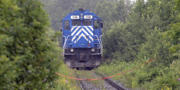 A train from the MMA (Montreal, Maine & Atlantic) railway is viewed as it was stopped by the RCMP and considered as a piece of evidence on July 9, 2013 near Lac -Megantic, Quebec. According to the owners of the train that leveled Lac-Mégantic, the simple rupture of a fuel or oil line, the fourth such rupture on a Montreal, Maine & Atlantic locomotive in the last eight years, may have been all that was needed to set in motion one of the most devastating rail disasters in Canadian history. Either way, both veteran railroaders and locals are disputing company assertions that local firefighters powering down a locomotive in order to put out a small fire was all it took to send 73 oil cars hurtling towards Lac-Mégantic. AFP PHOTO/STEEVE DUGUAY (Photo credit should read STEEVE DUGUAY/AFP/Getty Images)