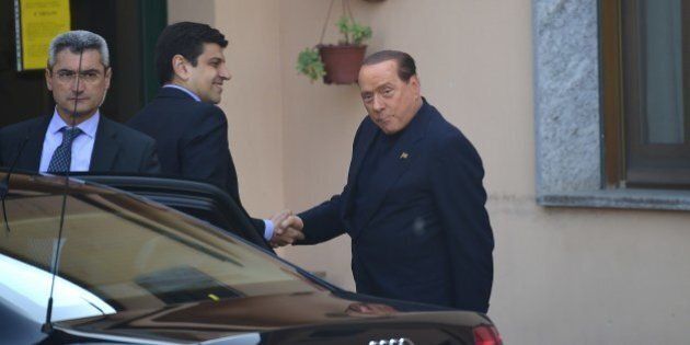 Italian former Prime Minister Silvio Berlusconi (R) arrives at the Catholic hospice in Cesano Boscone to begin community service for tax fraud on May 9, 2014. The billionaire tycoon, who was convicted last year and has been expelled from parliament, has been ordered to work once a week for up to a year as a volunteer in a hospice for Alzheimer's patients just outside Milan. AFP PHOTO / OLIVIER MORIN (Photo credit should read OLIVIER MORIN/AFP/Getty Images)