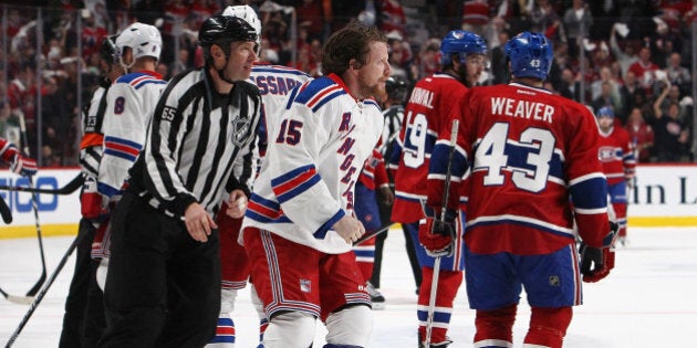 MONTREAL, QC - MAY 27:Derek Dorsett #15 of the New York Rangers is escorted off the ice after loosing...