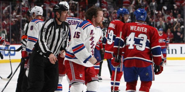 MONTREAL, QC - MAY 27:Derek Dorsett #15 of the New York Rangers is escorted off the ice after loosing to the Montreal Canadiens during Game Five of the Eastern Conference Final in the 2014 NHL Stanley Cup Playoffs at Bell Centre on May 27, 2014 in Montreal, Canada. Canadiens defeated the Rangers 7-4. (Photo by Francois Laplante/FreestylePhoto/Getty Images)