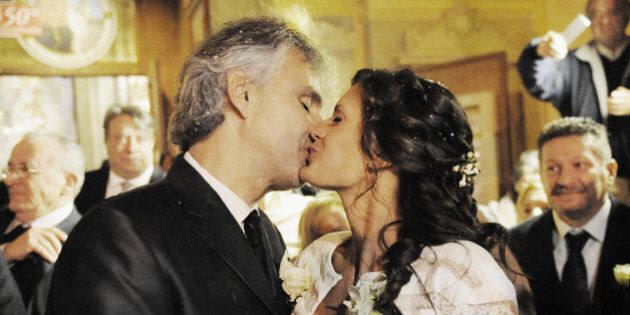 LIVORNO, ITALY - MARCH 21: Italian singer Andrea Bocelli and Veronica Berti kiss at Sanctuary of Madonna di Montenero after their wedding on March 21, 2014 in Livorno, Italy. (Photo by Laura Lezza/Getty Images)