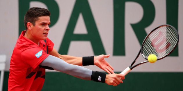 PARIS, FRANCE - JUNE 01: Milos Raonic of Canada returns a shot during his men's singles match against Marcel Granollers of Spain on day eight of the French Open at Roland Garros on June 1, 2014 in Paris, France. (Photo by Clive Brunskill/Getty Images)