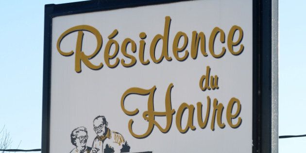A sign points to the retirement home 'Residence du Havre,' a pharmacy and a grocery store in L'Isle-Verte, a small town 450 kilometers (280 miles) northeast of Montreal with a population of around 1,400 people, January 24, 2014. Canadian firefighters on Thursday searched the ashes of the Quebec retirement home in L'Isle-Verte that burned to the ground on a bleak midwinter night, leaving more than 30 residents feared dead. Officials said the remains of three victims had been recovered and some 30 more were unaccounted for, while the local fire chief said rescuers were now searching for bodies. The blaze at the home, which housed around 50 to 60 elderly people in 52 units, broke out shortly after midnight. AFP PHOTO/Remi SENECHAL (Photo credit should read Remi Senechal/AFP/Getty Images)