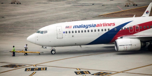 A Boeing Co. 737-800 aircraft operated by Malaysian Airline System Bhd. (MAS) is prepared for take off at Kuala Lumpur International Airport (KLIA) in Sepang, Malaysia, on Friday, March 14, 2014. Indian forces expanded the search for missing Malaysian Airlines Flight 370 to the Bay of Bengal after evidence mounted the plane with 239 people on board may have flown long after controllers lost contact with it a week ago. Photographer: Charles Pertwee/Bloomberg via Getty Images