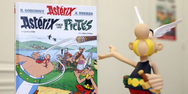 The new comic of the popular Asterix series 'Asterix chez les Pictes' (Asterix and the Picts), written by France's Jean-Yves Ferri and illustrated by France's Didier Conrad, is displayed on a table next to a figurine of the comic's characters Asterix on October 23, 2013 in Paris, on the eve of its release. AFP PHOTO / PATRICK KOVARIKRESTRICTED TO EDITORIAL USE, MANDATORY CREDIT OF THE ARTIST, TO ILLUSTRATE THE EVENT AS SPECIFIED IN THE CAPTION, NO ARCHIVE (Photo credit should read PATRICK KOVARIK/AFP/Getty Images)