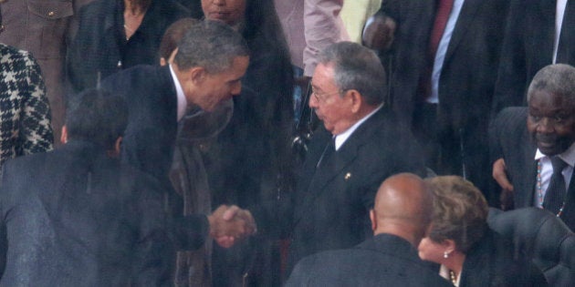 JOHANNESBURG, SOUTH AFRICA - DECEMBER 10: U.S. President Barack Obama (L) shakes hands with Cuban President Raul Castro during the official memorial service for former South African President Nelson Mandela at FNB Stadium December 10, 2013 in Johannesburg, South Africa. Over 60 heads of state have travelled to South Africa to attend a week of events commemorating the life of former South African President Nelson Mandela. Mr Mandela passed away on the evening of December 5, 2013 at his home in Houghton at the age of 95. Mandela became South Africa's first black president in 1994 after spending 27 years in jail for his activism against apartheid in a racially-divided South Africa. (Photo by Chip Somodevilla/Getty Images)