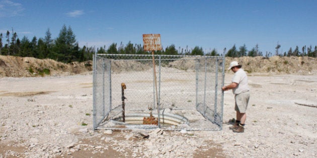 TO GO WITH AFP STORY by Clement SABOURIN, CANADA-QUEBEC-OIL-GAS-ENERGYDenis Duteau, former mayor of Anticosti, inspects a well on August 13, 2013 on Anticosti Island, Canada, where oil exploration operations were conducted in 2010. Duteau was hired as a lobbyist by Petrolia, a Quebec oil company that plans to start pumping shale oil. Between 800 and 1,000 tourists are expected to visit Anticosti in the summer of 2013, but every Fall as many as 4,000 hunters come to the island in the Gulf of St. Lawrence. The size of the French island of Corsica in the Mediterranean, Anticosti has only 216 inhabitants. Quebec's Petrolia gas exploration company announced a partnership with the community to install an hydrocarbons exploration program scheduled to star in 2014. Economist specializing in energy issues, Pierre-Olivier Pineau believes that fracturing gas 'increases opportunities for fugitive gas leaks' that are 'worse for the greenhouse effect because it is methane that escapes without being checked.' AFP PHOTO / Clement SABOURIN (Photo credit should read Clement Sabourin/AFP/Getty Images)