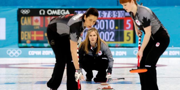 Canada's skip Jennifer Jones, center, watches her teammates Jill Officer, left, and Dawn McEwen, right, during the women's curling competition against Denmark at the 2014 Winter Olympics, Thursday, Feb. 13, 2014, in Sochi, Russia. (AP Photo/Wong Maye-E)