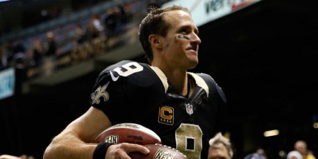 NEW ORLEANS, LA - DECEMBER 08: Drew Brees #9 of the New Orleans Saints celebrates after defeating the Carolina Panthers at Mercedes-Benz Superdome on December 8, 2013 in New Orleans, Louisiana. (Photo by Chris Graythen/Getty Images)