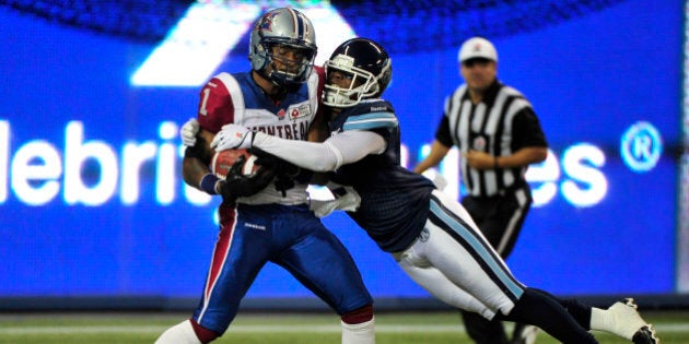 TORONTO, ON - SEPTEMBER 3 - Montreal's Arland Bruce (left) makes a touchdown catch with pressure by Toronto's Jermaine Gabriel during the 1st half as the Toronto Argonauts host the Montreal Alouettes during CFL action at the Rogers Centre on September 3, 2013. (Carlos Osorio/Toronto Star via Getty Images)