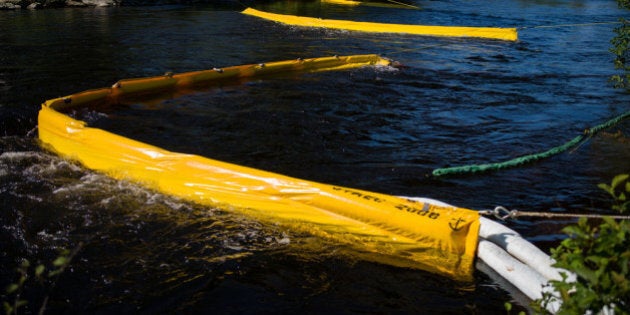 LAC-MEGANTIC, CANADA - JULY 13: Oil catch filters on the Chaudire River, July 13, 2013 in Lac-Megantic, Quebec, Canada. A train derailed and exploded into a massive fire that flattened dozens of buildings in the town's historic district, leaving 60 people dead or missing in the early morning hours of July 6. (Photo by Ian Willms/Getty Images)