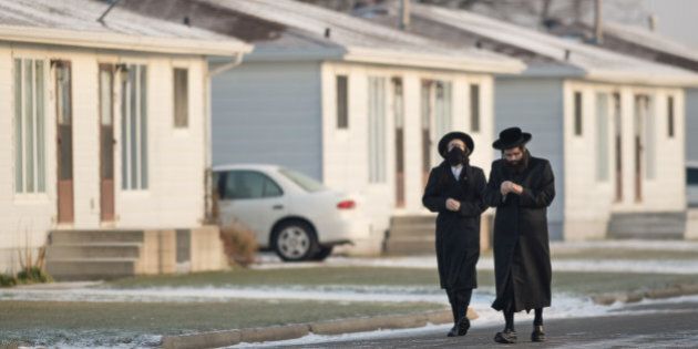 CHATHAM - NOVEMBER 29 - Lev Tahor community members, on November 29, 2013, seen at their new location in Chatham, Ontario, after leaving Quebec last week. Members of the community walks toward the building for morning prayers. (Rick Madonik/Toronto Star via Getty Images)