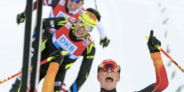Eric Frenzel of Germany, right, celebrates in front of Jason Lamy Chappuis of France, center, and Mario Stecher of Austria, left, in the finish area during the men Nordic combined team Gundersen 4x5 km competition at the Nordic Combined FIS World Cup in Oberstdorf, southern Germany, Saturday, Jan. 25, 2014. Germany won the competition. France placed second and Austria placed third. (AP Photo/Jens Meyer)