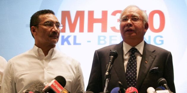 KUALA LUMPUR, MALAYSIA - MARCH 15: Datuk Hishammuddin Hussein (L), acting Minister of Transport and Malaysian Prime Minister Najib Abdul Razak update the media on the search and rescue plan for the missing MAS Airlines flight MH370 during a press conference on March 15, 2014 in Kuala Lumpur, Malaysia. During the press conference the Prime Minister said that investigators had discovered evidence from satellite and radar systems indicating that the communication systems of the aircraft had been intentionally disabled. The search for the plane in the South China Sea has now been abandoned with the focus switching to two flight corridors, the first stretching from the border of Kazakhstan and Turkmenistan to northern Thailand and a second stretching from Indonesia to the South Indian Ocean.The missing aircraft was carrying 227 passengers and 12 crew. (Photo by How Foo Yeen/Getty Images)