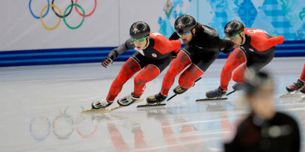 Charles Hamelin of Canada, centre, and fellow team members train during a short track speedskating practice session at the Iceberg Skating Palace ahead of the 2014 Winter Olympics, Thursday, Feb. 6, 2014, in Sochi, Russia. (AP Photo/Vadim Ghirda)