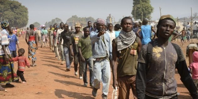 Anti-Balaka combattants patrol near Mpoko Bangui airport where 100.000 people have fled on January 8, 2014. African leaders are to meet in Chad on January 9, to discuss the future of Central African Republic President Michel Djotodia, in a bid to end the sectarian violence ripping the country apart. Djotodia and his Prime minister Nicolas Tiangaye are on their way to N'Djamena. AFP PHOTO ERIC FEFERBERG (Photo credit should read ERIC FEFERBERG/AFP/Getty Images)