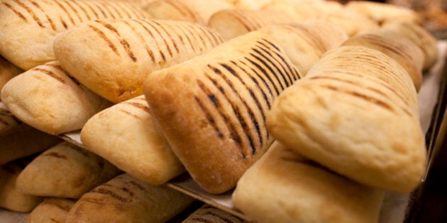 Bread is seen a tray as an employee replenishes stock in the bakery at a Tesco Metro supermarket in London, U.K., on Monday, April 16, 2012. Tesco Plc, the U.K.'s largest supermarket chain, will reduce spending by more than 350 million pounds ($559 million) to ensure it can continue its dividend yield, according to JPMorgan Cazenove. Photographer: Simon Dawson/Bloomberg via Getty Images