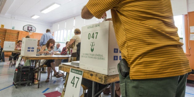 People vote on September 4, 2012 in l'Assomption, Quebec, Canada. Voting started Tuesday in a Quebec election expected to return separatists to power, buoyed by rising frustration with the current leadership and months of student protests over a planned tuition hike. Nearly six million voters in the country's only majority French-speaking province will choose 125 lawmakers. And pre-election polls point to the Parti Quebecois (PQ) coming out on top, though without a full majority. The PQ has been in the opposition since its 2003 defeat by the Liberals, led by Jean Charest, who is only the second person since the 1950s to have served three terms as Quebec premier. AFP PHOTO / ROGERIO BARBOSA (Photo credit should read ROGERIO BARBOSA/AFP/GettyImages)