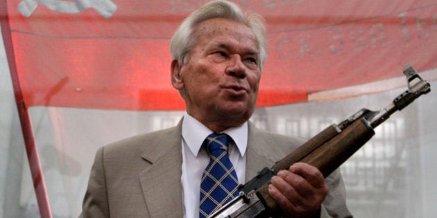 Famous Russian weapon designer Mikhail Kalashnikov, 87, poses with the first model of his legendary AK-47 assault rifle during a ceremony of celebrating of the 60th anniversary of his rifle in Moscow, 06 July 2007. Russian President Vladimir Putin hailed the AK-47 automatic rifle on Thursday as a symbol of Russia's 'creative genius' in a statement to a conference dedicated to the weapon's 60th anniversary. Kalashnikov called for a battle against makers of counterfeit AK-47s, which deprives Russia of an estimated two billion dollars (1.47 billion euros) each year. AFP PHOTO/ DIMA KOROTAYEV (Photo credit should read DIMA KOROTAYEV/AFP/Getty Images)