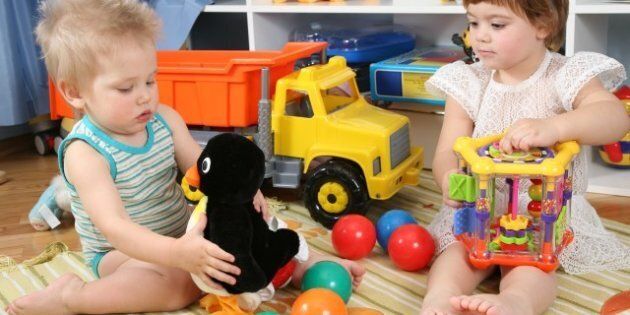 two children in playroom with toys