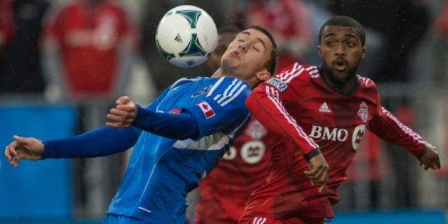 TORONTO - OCTOBER 26 - Montreals Andrew Wenger controls the ball in front of Bright Dike of TFC. Toronto FC takes on Montreal Impact on October 26, 2013, at BMO Field for the last regular season game this year. TFC has one of the worst winning percentages ever, as they conclude another dismal year. (Rick Madonik/Toronto Star via Getty Images)