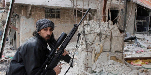 A rebel fighter from the Free Syrian Army holds a position with a Belgium made FAL rifle at a front line in the Salah al-Din neighbourhood of the northern Syrian city of Aleppo, on December 1, 2013. A Syrian regime air raid on the northern town of Al-Bab, in the Aleppo province, killed at least eleven people, in a second day of deadly strikes, the Syrian Observatory for Human Rights said. AFP PHOTO / MOHAMMED AL-KHATIEB (Photo credit should read MOHAMMED AL-KHATIEB/AFP/Getty Images)