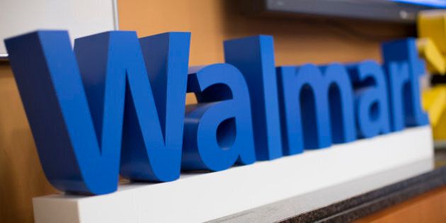 The Wal-Mart Stores Inc. logo is displayed during a media briefing with Scott Price, chief executive officer for Asia at Wal-Mart, in Hong Kong, China, on Wednesday, Dec. 18, 2013. Indias antitrust body approved Wal-Marts purchase of a stake in its former partner Bharti Enterprises Pvt., Price said in Hong Kong today. Photographer: Jerome Favre/Bloomberg via Getty Images