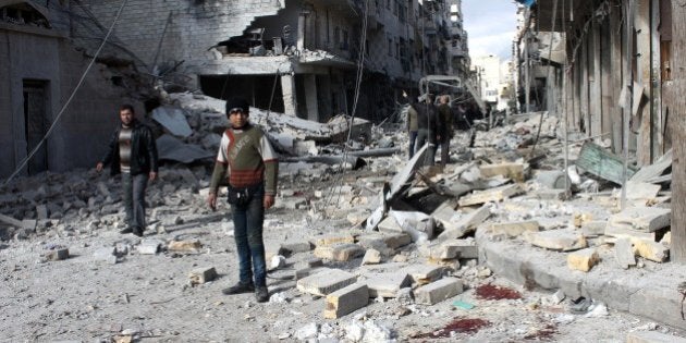 Syrians stand in a destroyed street following a reported airstrike by government forces on the northern Syrian city of Aleppo on January 28, 2014. Syria's warring sides will not meet again at peace talks in Geneva, the opposition said, after a morning session broke up with the regime accusing Washington of 'arming terrorists'. AFP PHOTO / AMC / FADI AL-HALABI (Photo credit should read Fadi al-Halabi/AFP/Getty Images)