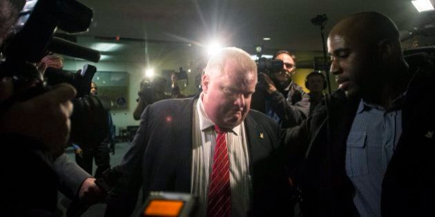 Toronto Mayor Rob Ford leaves city hall for the day after councillors passed motions to limit his powers on Monday November 18, 2013 THE CANADIAN PRESS/Chris Young