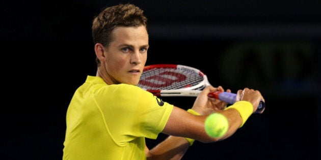 MELBOURNE, AUSTRALIA - JANUARY 15: Vasek Pospisil of Canada plays a backhand in his first round singles match against Matthew Ebden of Australia during day three of the 2014 Australian Open at Melbourne Park on January 15, 2014 in Melbourne, Australia. (Photo by Quinn Rooney/Getty Images)