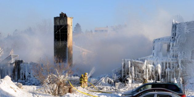 Smoke rises from the burnt remains of a retirement home in L'Isle-Verte on January 23, 2014. Firefighters searched the ashes of a Quebec retirement home that burned to the ground on a bleak midwinter night, leaving more than 30 residents feared dead. Officials said the remains of three victims had been recovered and some 30 more were unaccounted for, while the local fire chief said rescuers were now searching for bodies. AFP PHOTO/Remi SENECHAL (Photo credit should read Remi Senechal/AFP/Getty Images)