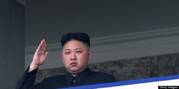 TO GO WITH Oly-2012-PRK,FEATURE (FILES) This file photo taken on April 15, 2012 shows North Korean leader Kim Jong-Un saluting as he watches a military parade to mark 100 years since the birth of the country's founder and his grandfather, Kim Il-Sung, in Pyongyang. He lacks the toned physique of an Olympian but 'dear respected' leader Kim Jong-Un will be the inspiration when North Korea's athletes go for gold at the London Olympics. North Korea are aiming for a record number of medals in London in what would be a timely boost for Kim, the new face of the country's ruling dynasty and its all-pervasive personality cult. AFP PHOTO / FILES / Ed Jones (Photo credit should read Ed Jones/AFP/GettyImages)