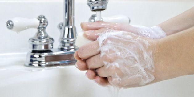 child washing hands with soap...
