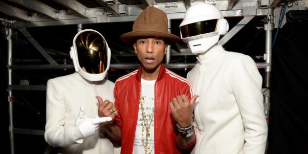 LOS ANGELES, CA - JANUARY 26: Recording artist Pharrell Williams (center) and Daft Punk attend the 56th GRAMMY Awards at Staples Center on January 26, 2014 in Los Angeles, California. (Photo by Michael Kovac/WireImage)
