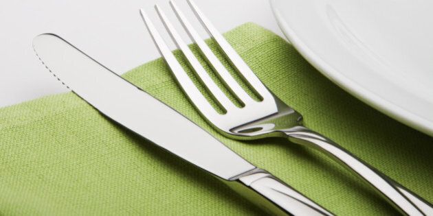 fork and knife on a green...