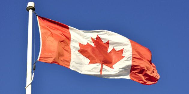 canadian flag flying in the wind