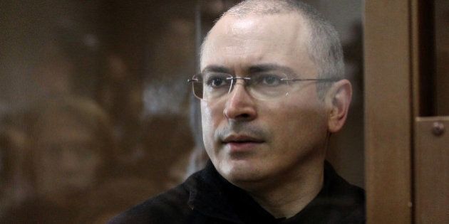 Russian ex-oil tycoon Mikhail Khodorkovsky stands behind a glass wall at a courtroom in Moscow, on May 17, 2011. A Russian court adjourned until May 24 the appeal of Khodorkovsky against his conviction in a fraud trial that sparked global condemnation, an AFP correspondent reported. AFP PHOTO / ALEXEY SAZONOV (Photo credit should read Alexey SAZONOV/AFP/Getty Images)